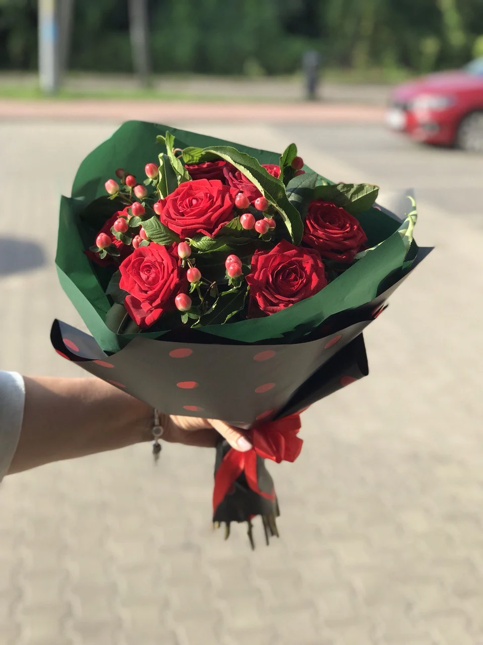 Elegancki bukiet z czerwonych róż i owoców hypericum